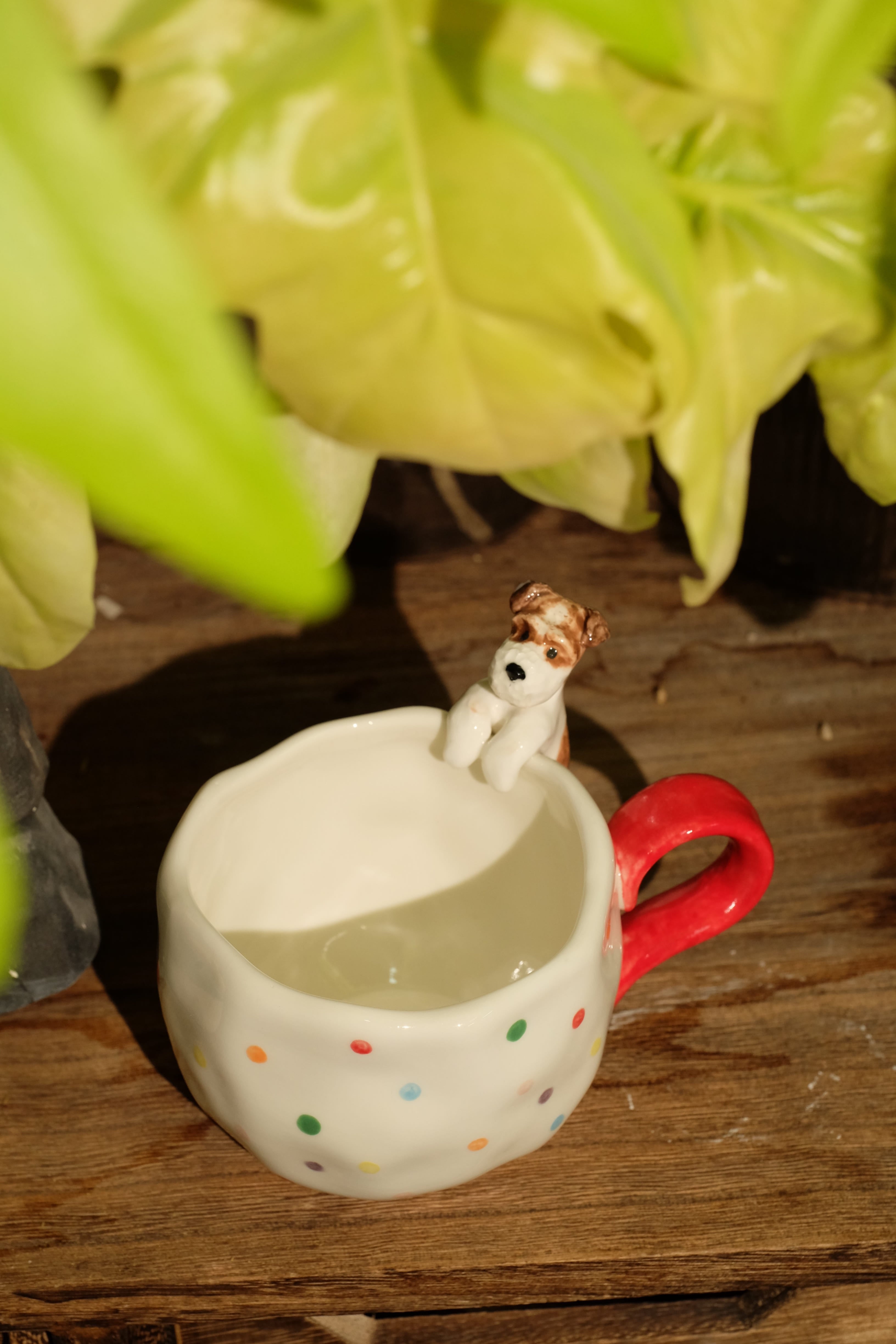 Everlou polka-dot mug with a hand-sculpted dog clinging to the rim