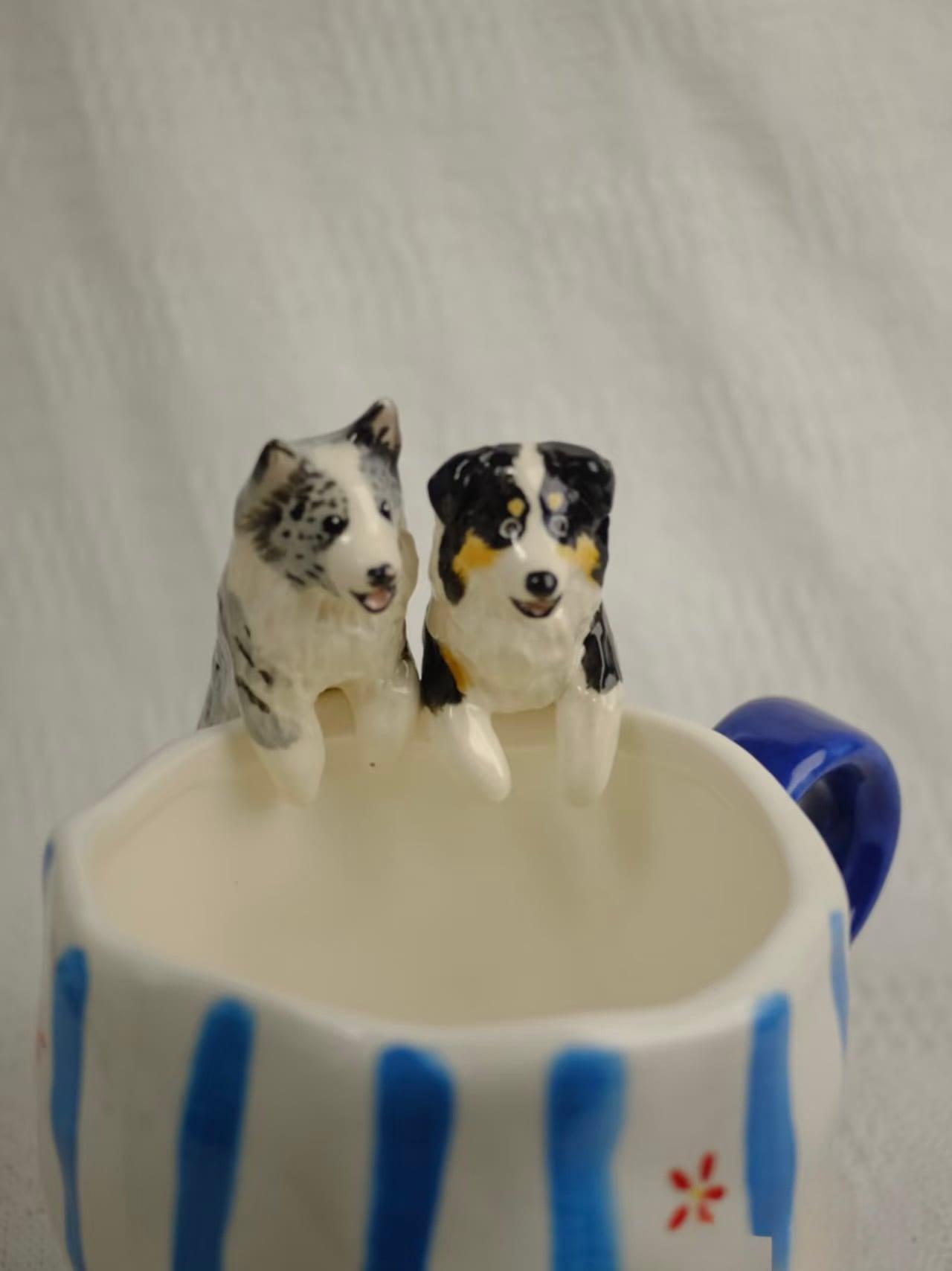 Close-up of a hand-sculpted dog figure inside an Everlou mug